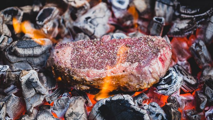 Meat cooking on coals