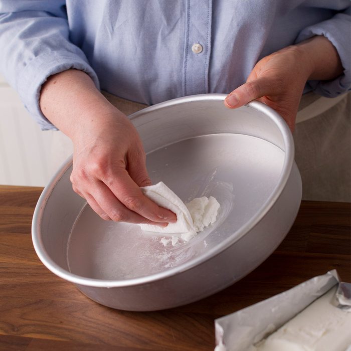 greasing a cake pan