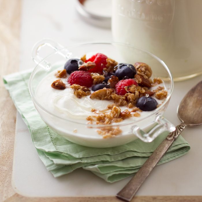 bowl of yogurt topped with fruit and granola