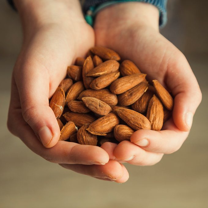 Holding fresh almonds in hands
