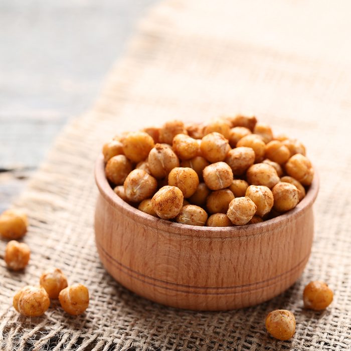 Roasted chickpeas in bowl on gray wooden table