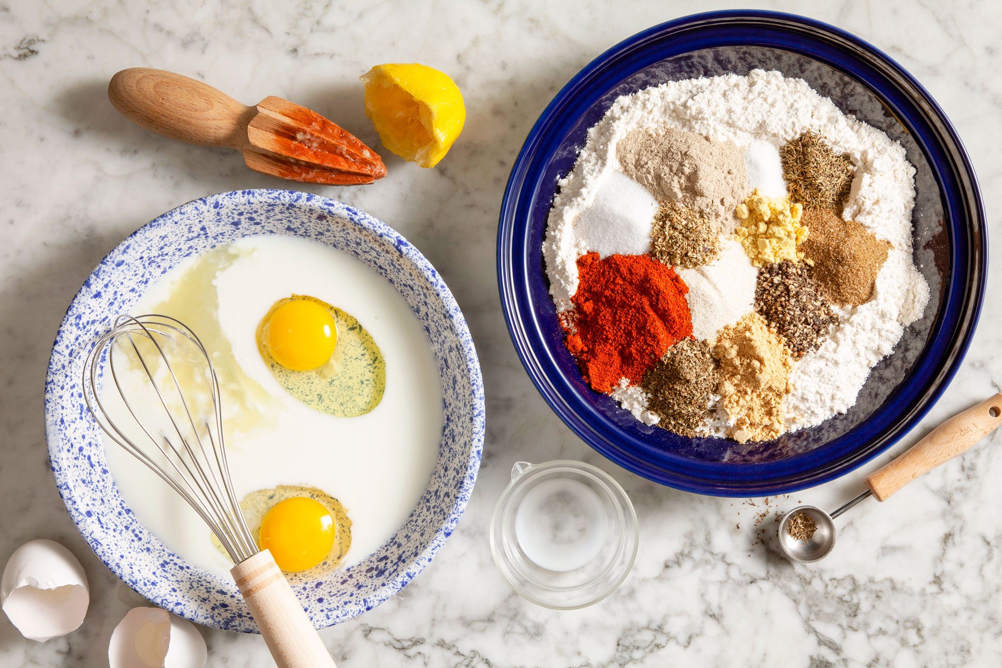 Mix of Chicken Coating Dry Ingredients in a Bowl and Milk, Egg and Lemon in Another Bowl