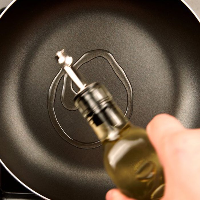 swirling olive oil into a skillet