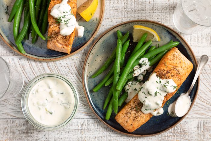 Pan Seared Salmon With Dill Sauce on a white table
