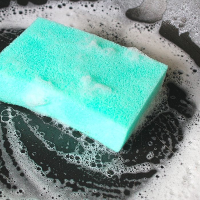 Cleaning Sponge with foam on a frying pan.