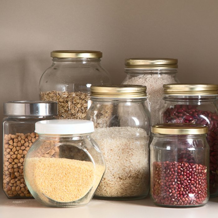 Collection of grain products in storage jars in pantry
