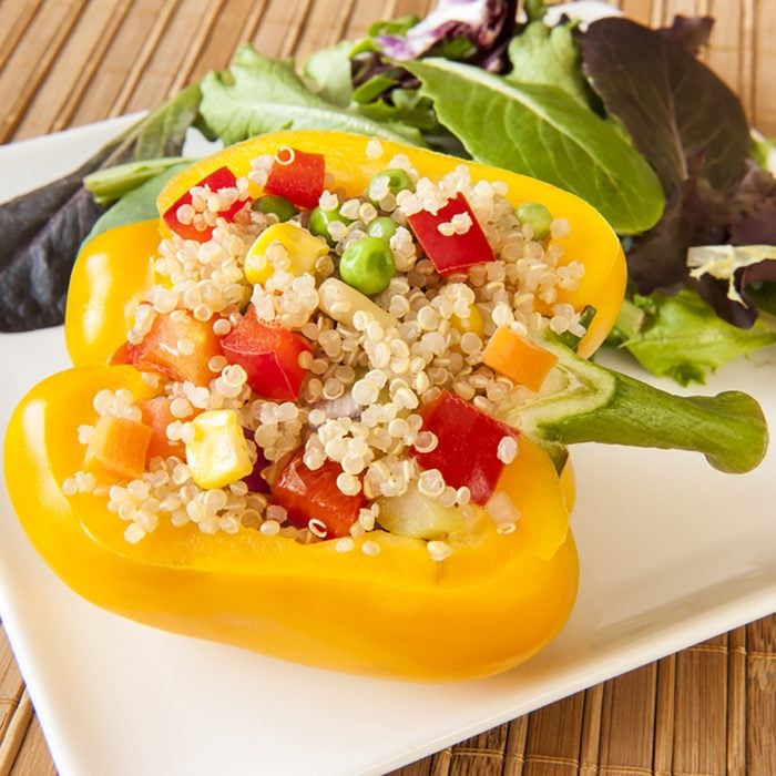 Yellow pepper stuffed with quinoa and mixed vegetables with green salad