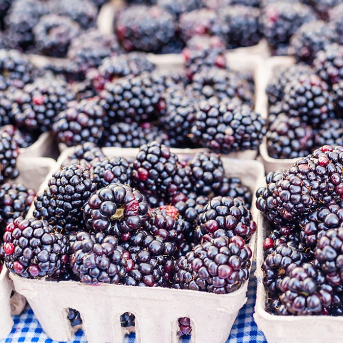 Boxes of organic blackberries for sale at local farmers market.