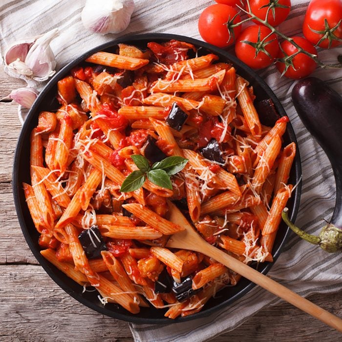 Italian food: Pasta alla Norma close-up on the table and ingredients