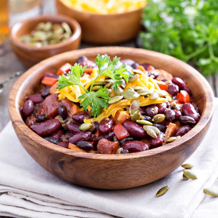 Vegetarian chili with red and black beans, cheddar and pumpkin seeds