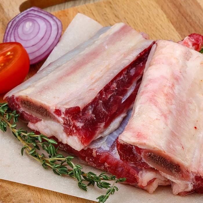 Raw beef ribs with rosemary and thyme - ready for cooking