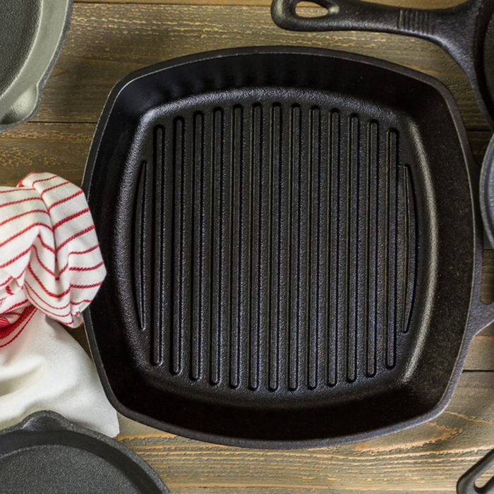 Cast iron skillet on rustic wood table.