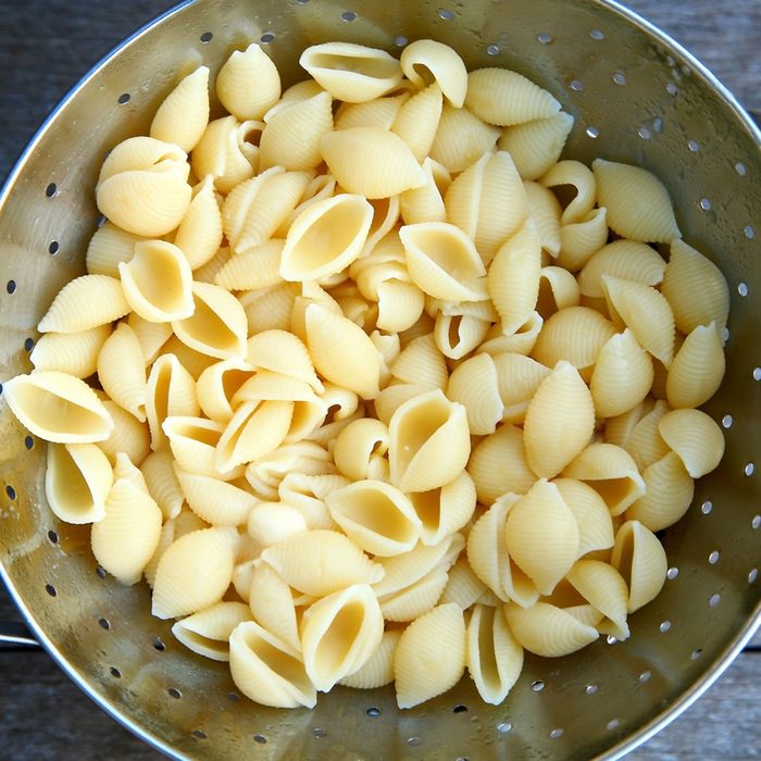 freshly cooked pasta shells in a colander