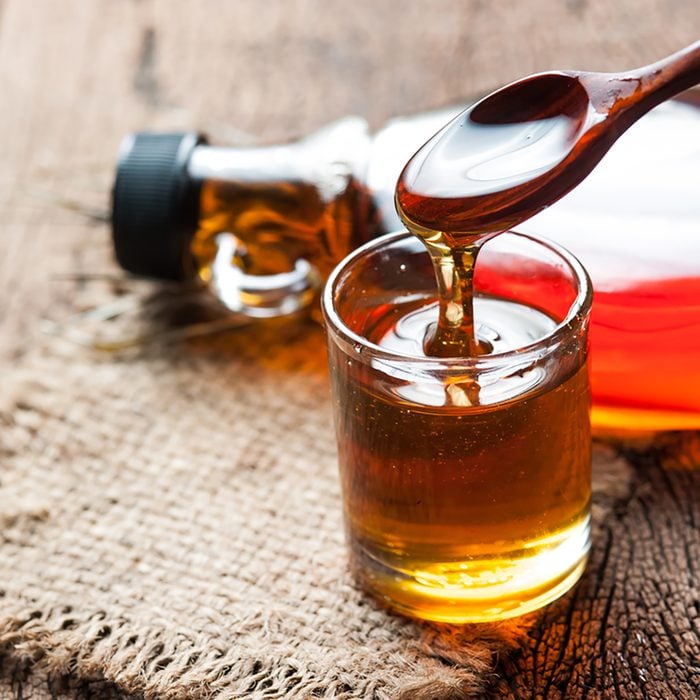 maple syrup in glass bottle on wooden table