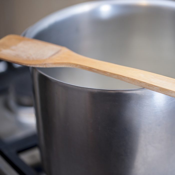 Wooden spoon over a pot on the stove