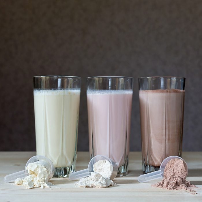Fresh milk, chocolate, blueberry and banana drinks on table, assorted protein cocktails.