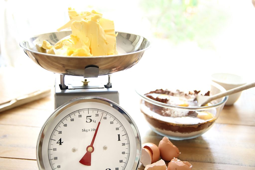 Butter being weighed for a chocolate cake; Shutterstock ID 434129020