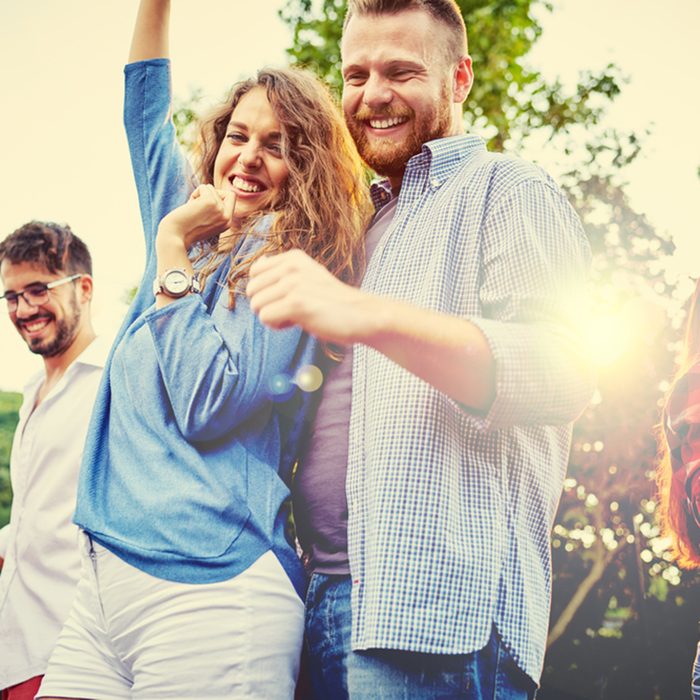 Young people dancing in backyard