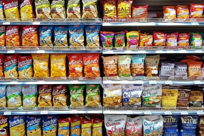 Bangkok, TH - FEBRUARY 14, 2017: Potato chips and snack foods in supermarket shelf that are the cause of an increase fat person.; Shutterstock ID 590612882