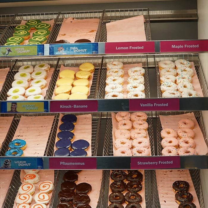 Variety of Dunkin' Donuts on trays in a display case. Founded in 1950, Dunkin' Donuts is an American global donut company and coffeehouse chain