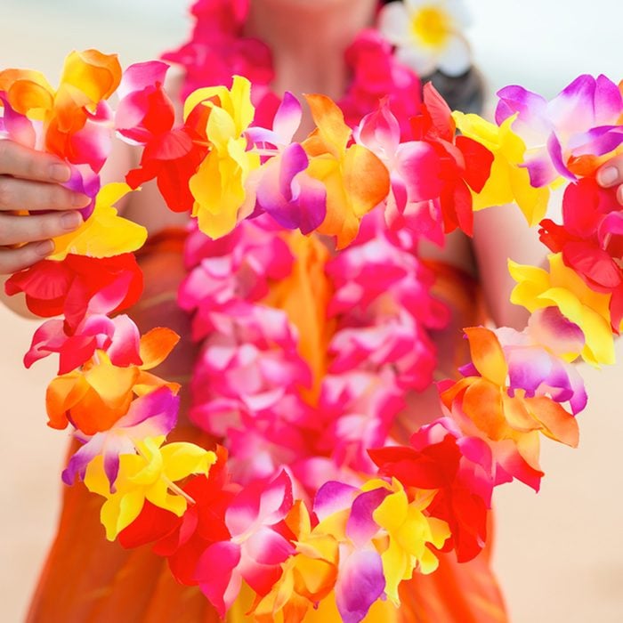 Beautiful floral Hawaiian Lei in the hands of a close-up woman