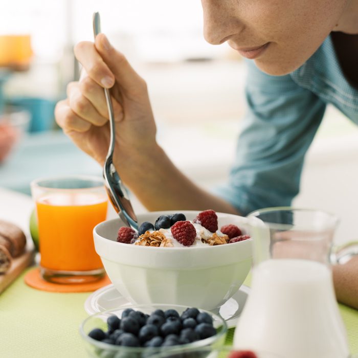 Woman having an healthy delicious breakfast at home