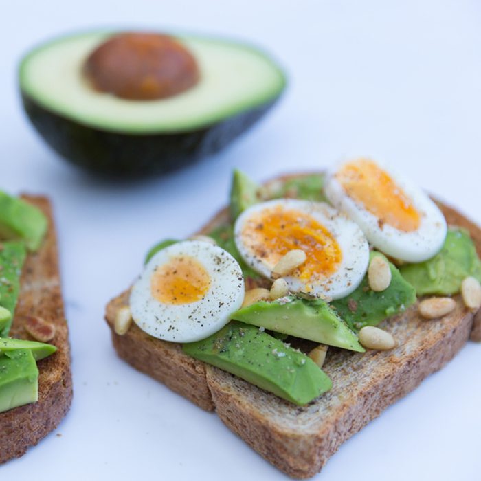 Healthy eggs and avocado on toasted bread