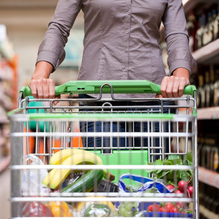 customer shopping at supermarket with trolley
