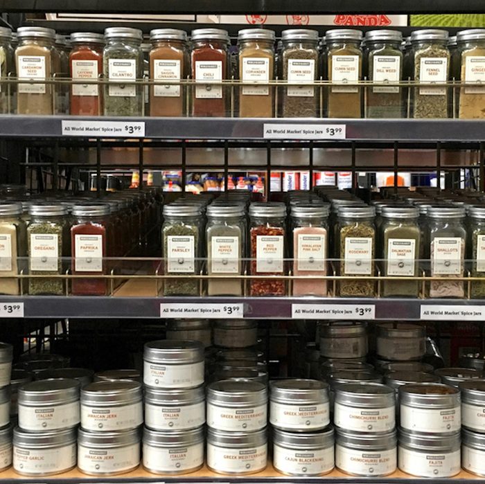 Grocery store shelf with jars of herbs and spices. Fresh herbs and spices can take a dish from good to great.;