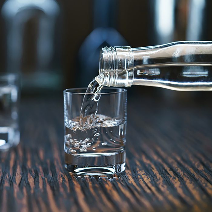 2 Russian vodka pouring from the bottle into glass in a bar, selective focus; Shutterstock ID 569664118; Job (TFH, TOH, RD, BNB, CWM, CM): Taste of Home