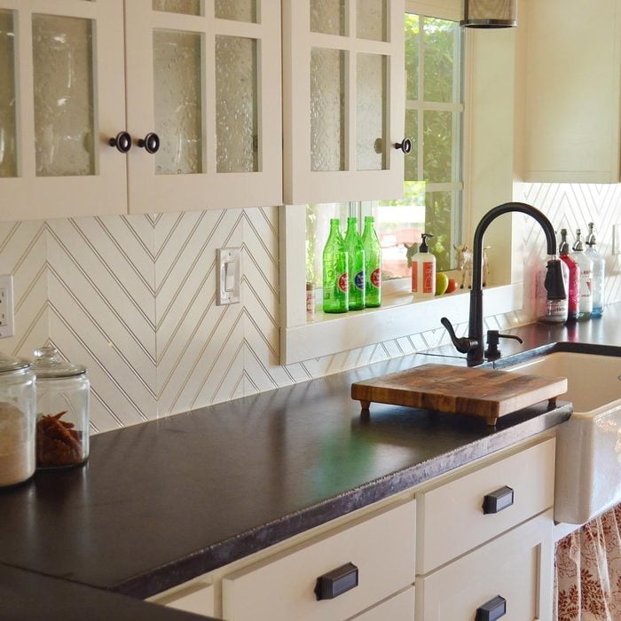 Kitchen with patterned wood backsplash