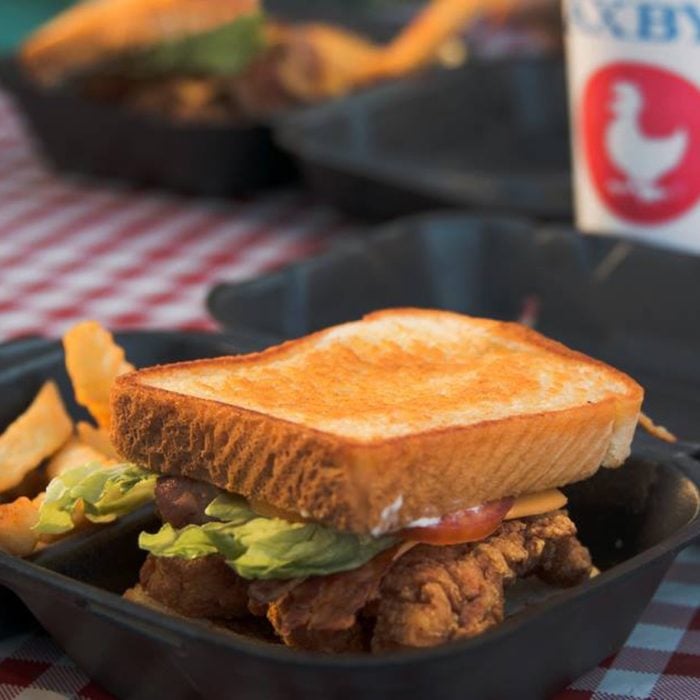 Zaxby's sandwich in a take-out container with fries