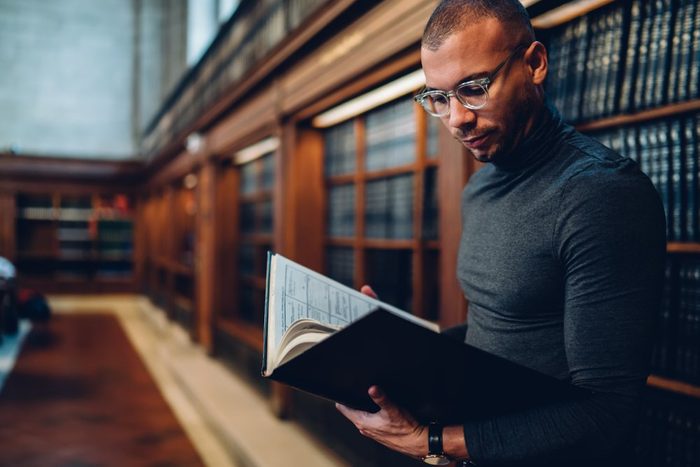 Man reading a book in a library