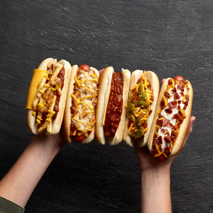 Two hands full of hotdogs