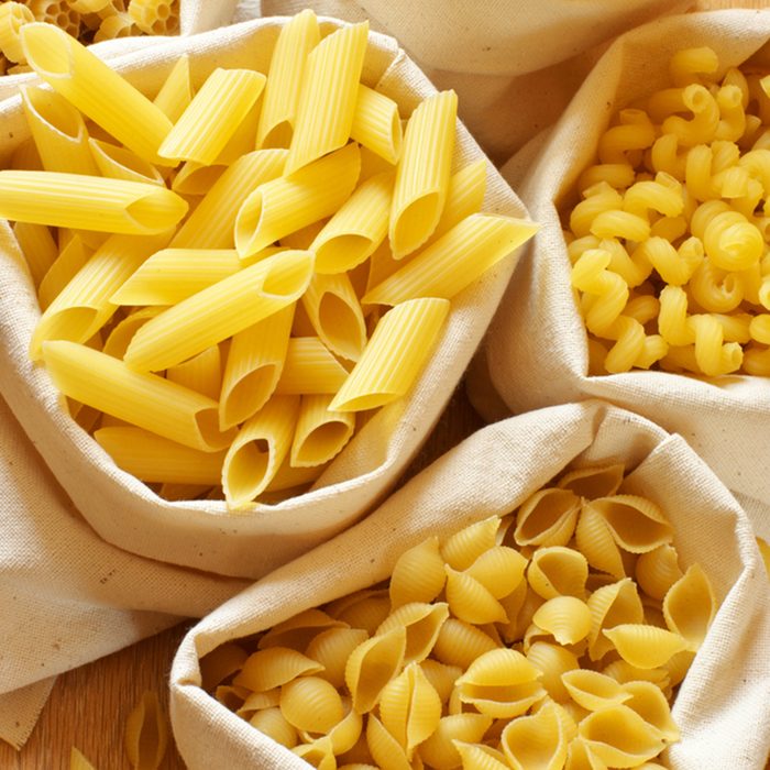 Close-up of assorted pasta in jute bags.