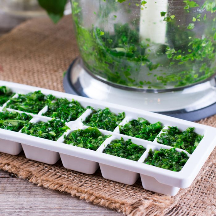 Frozen cubes of herbs on a wooden table