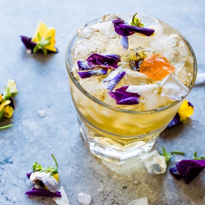Herbal Iced Tea Cocktail with Edible Flowers and Crushed Ice