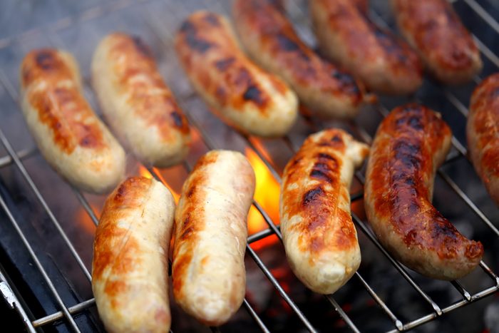Nicely grilled sausages on a whole background.