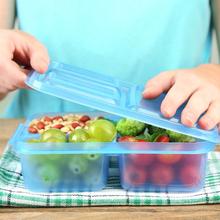 Woman making tasty vegetarian lunch