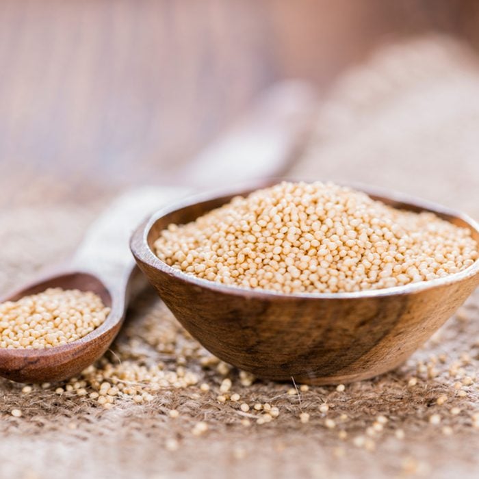 Bowl with Amaranth on wooden background