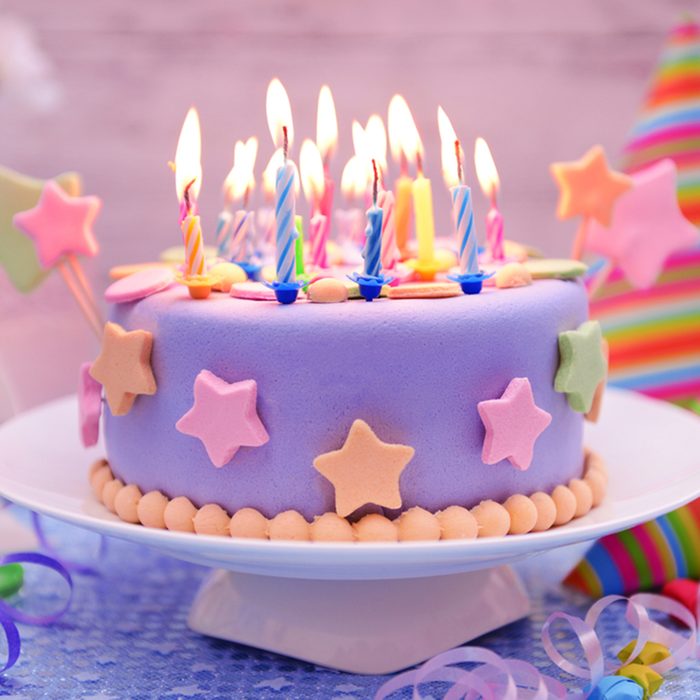 Delicious birthday cake on table on light background