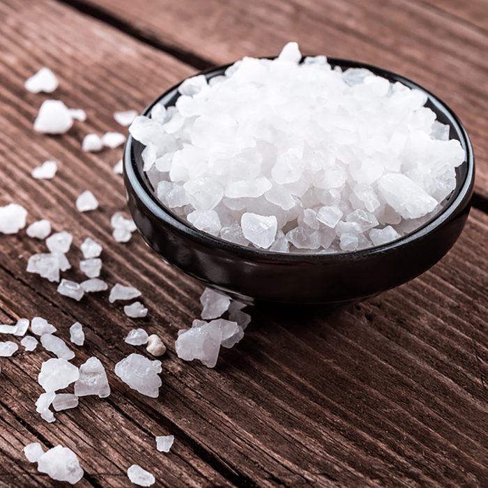 sea salt in bowl on wooden background