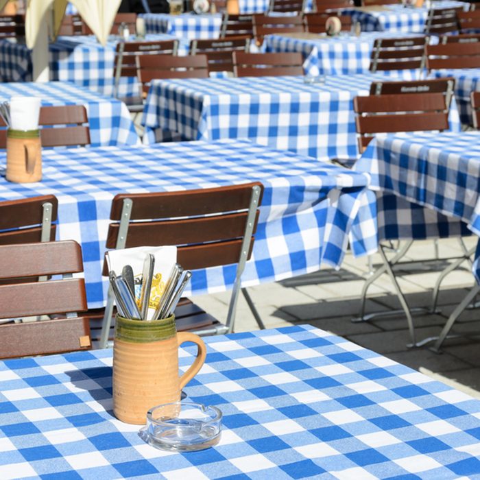 Empty Bavarian Beer garden with blue white tablecloth.