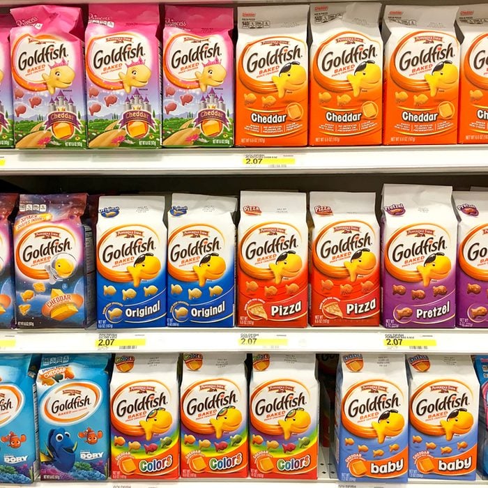 Grocery Store Shelf with packages of Goldfish Crackers, many flavors.