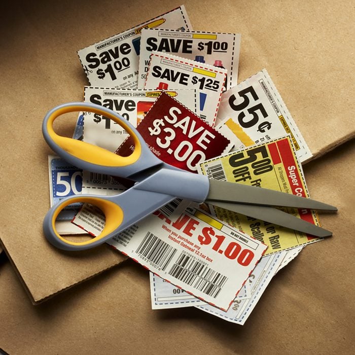 Savings coupons and scissors shot on shopping bags with soft drop shadow