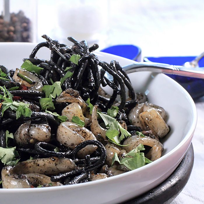 View of delicious black pasta with squids (cuttlefish) and ink