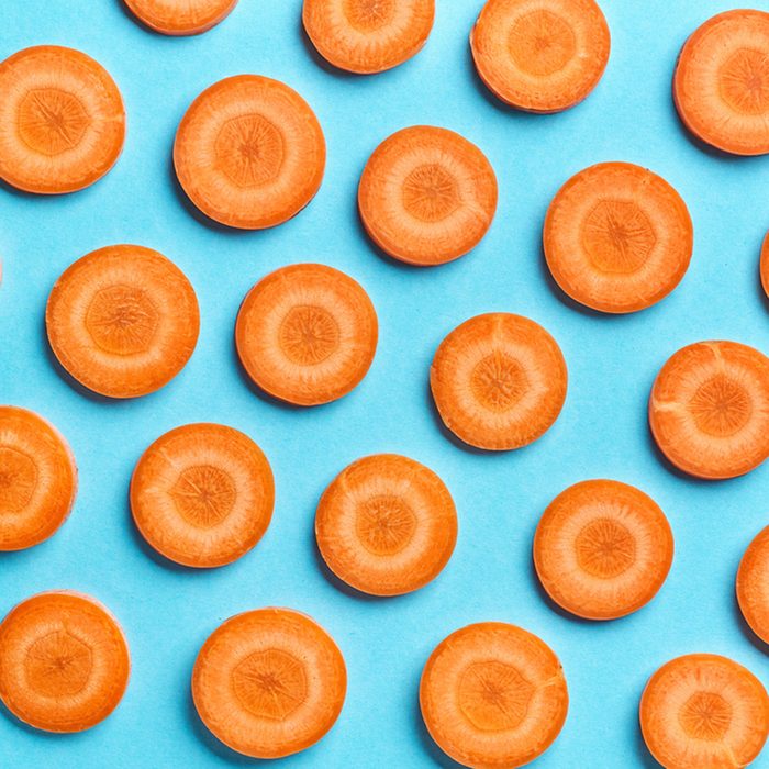 sliced carrot on blue color background