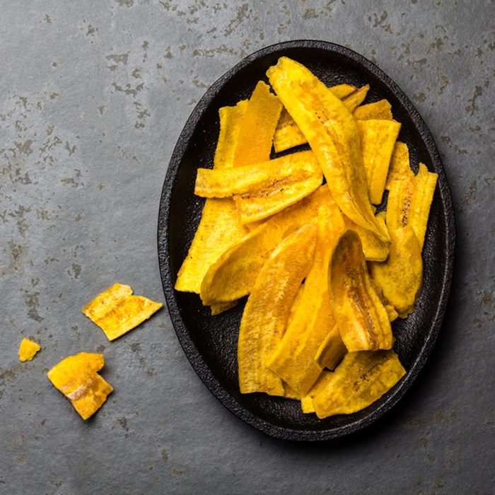 Healthy Homemade banana Plantain Chips on black plate