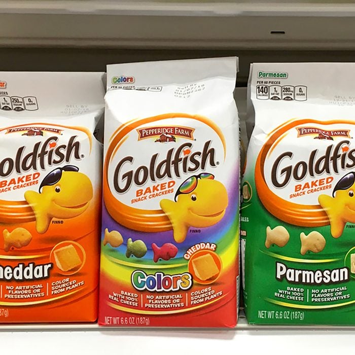 Grocery shelf with packages of Goldfish cheese crackers. 