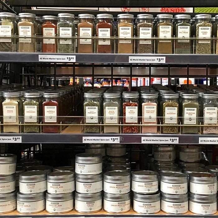 Grocery store shelf with jars of herbs and spices. Fresh herbs and spices can take a dish from good to great.